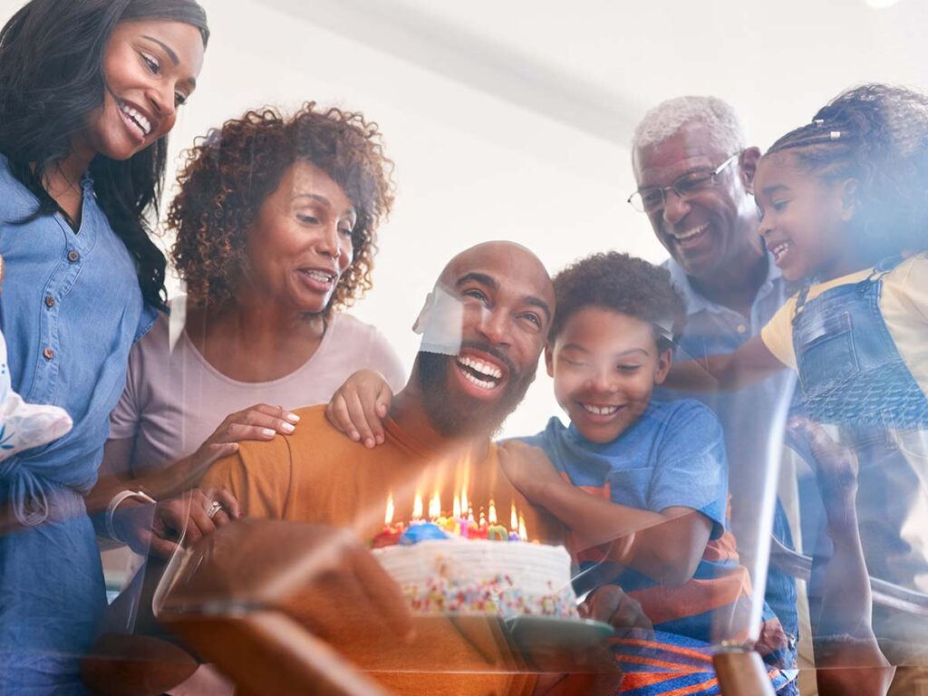 Multi-Generation African American Family Celebrating Fathers Birthday At Home Together