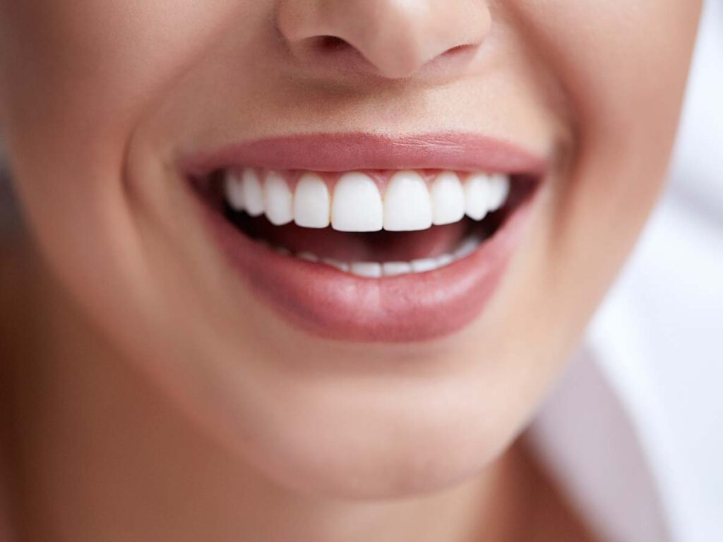 Healthy white smile close up. Beauty woman with perfect smile, lips and teeth. 