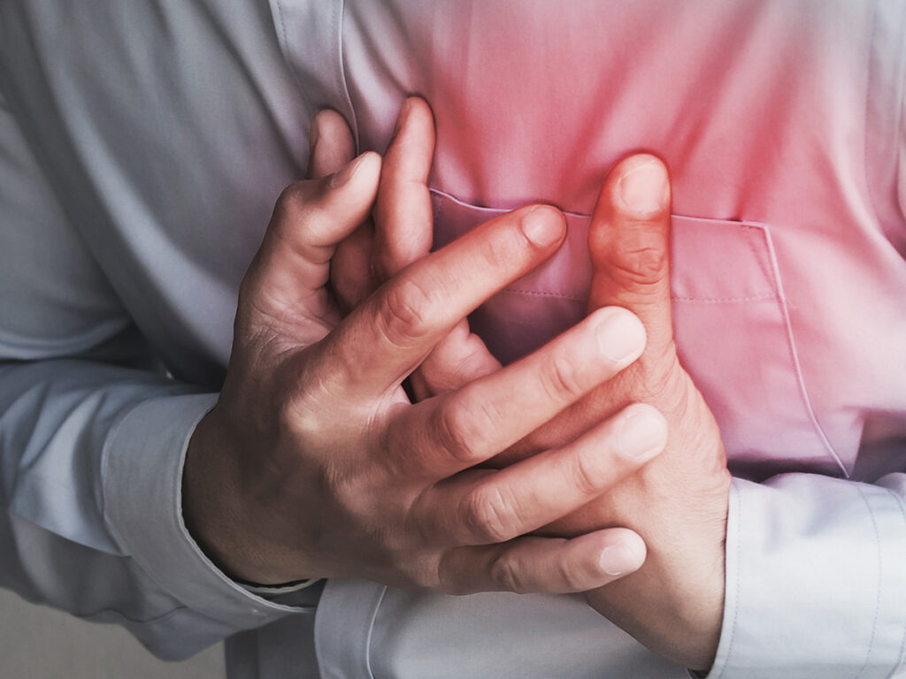 a man clutching his chest in pain