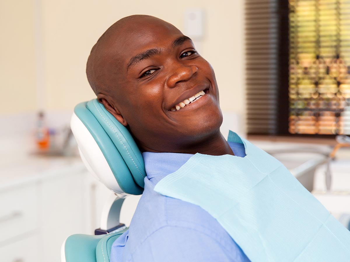 Smiling man sitting in a dental chair