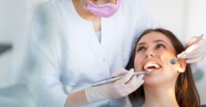 Person smiling at dentist during exam
