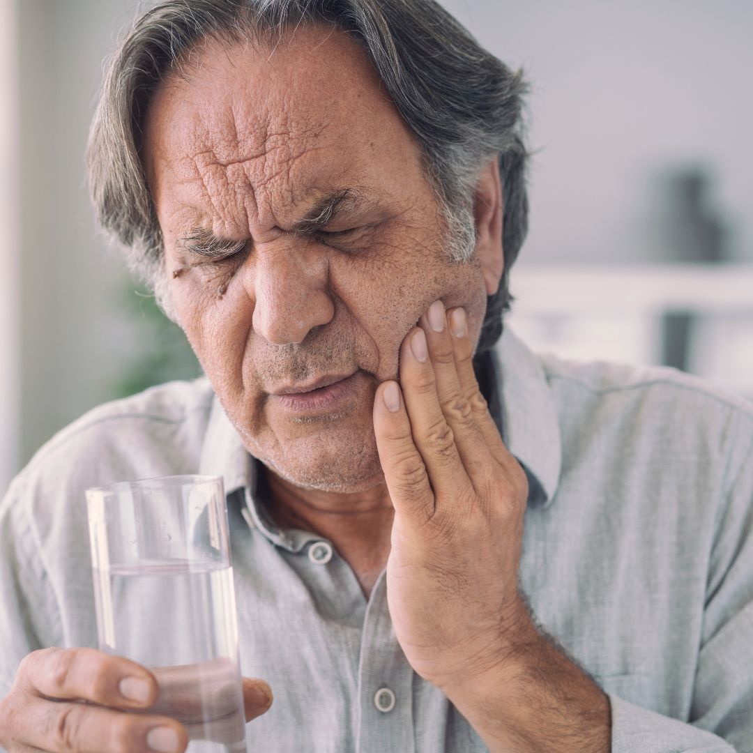 man with tooth pain from drinking cold water