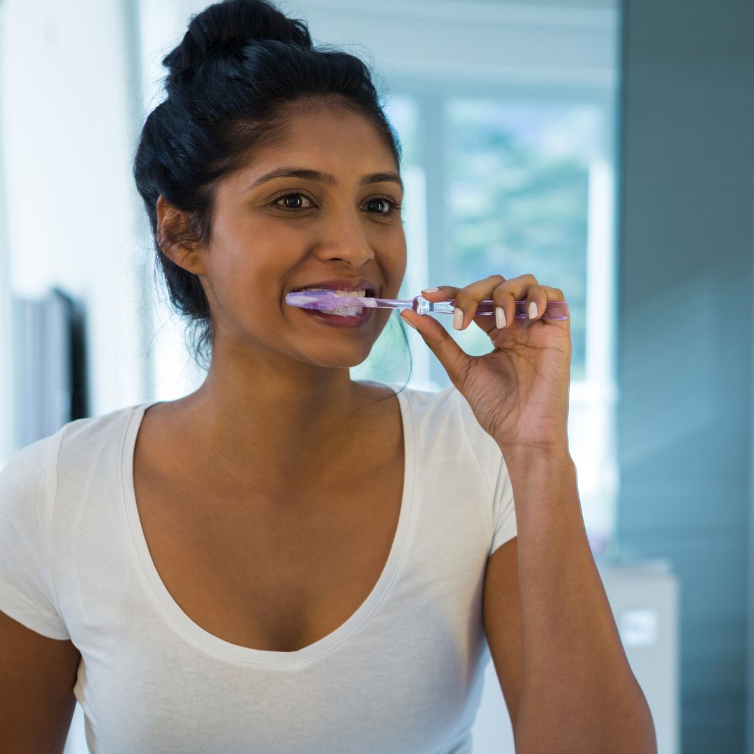 woman brushing teeth