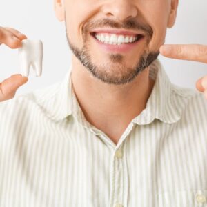 man pointing at his smile