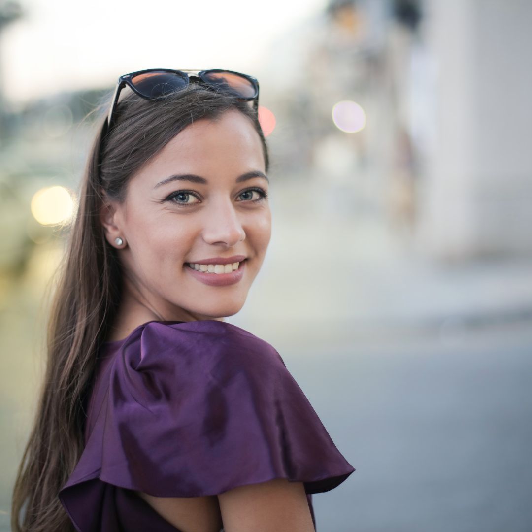 a woman looking over her shoulder and smiling