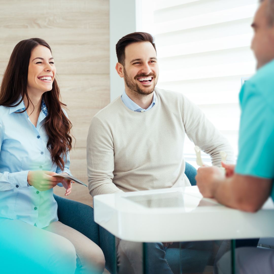 Couple talking to dentist