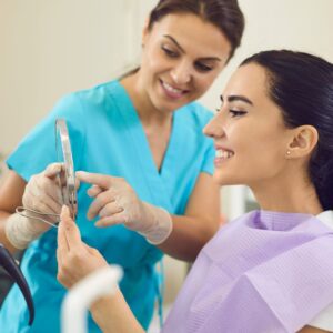 a woman smiling at her teeth
