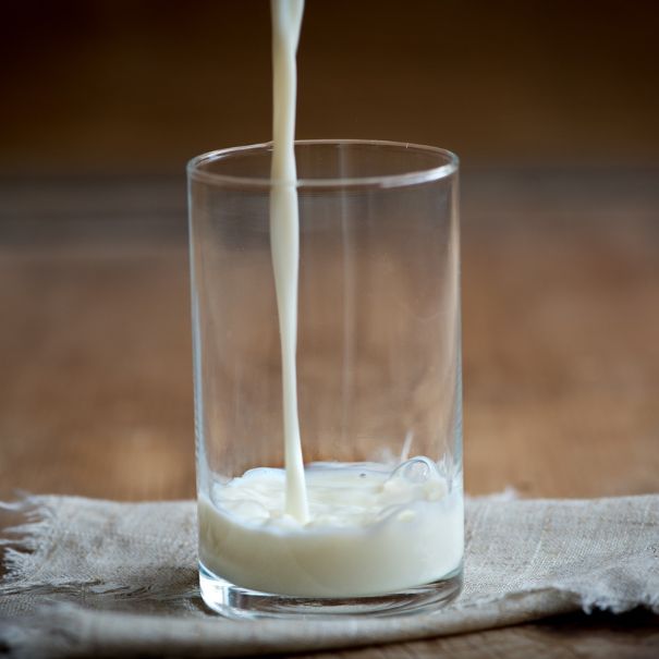 Pouring a small glass of milk