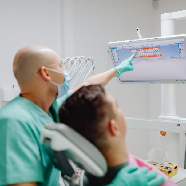 Patient viewing dental chart with dentist
