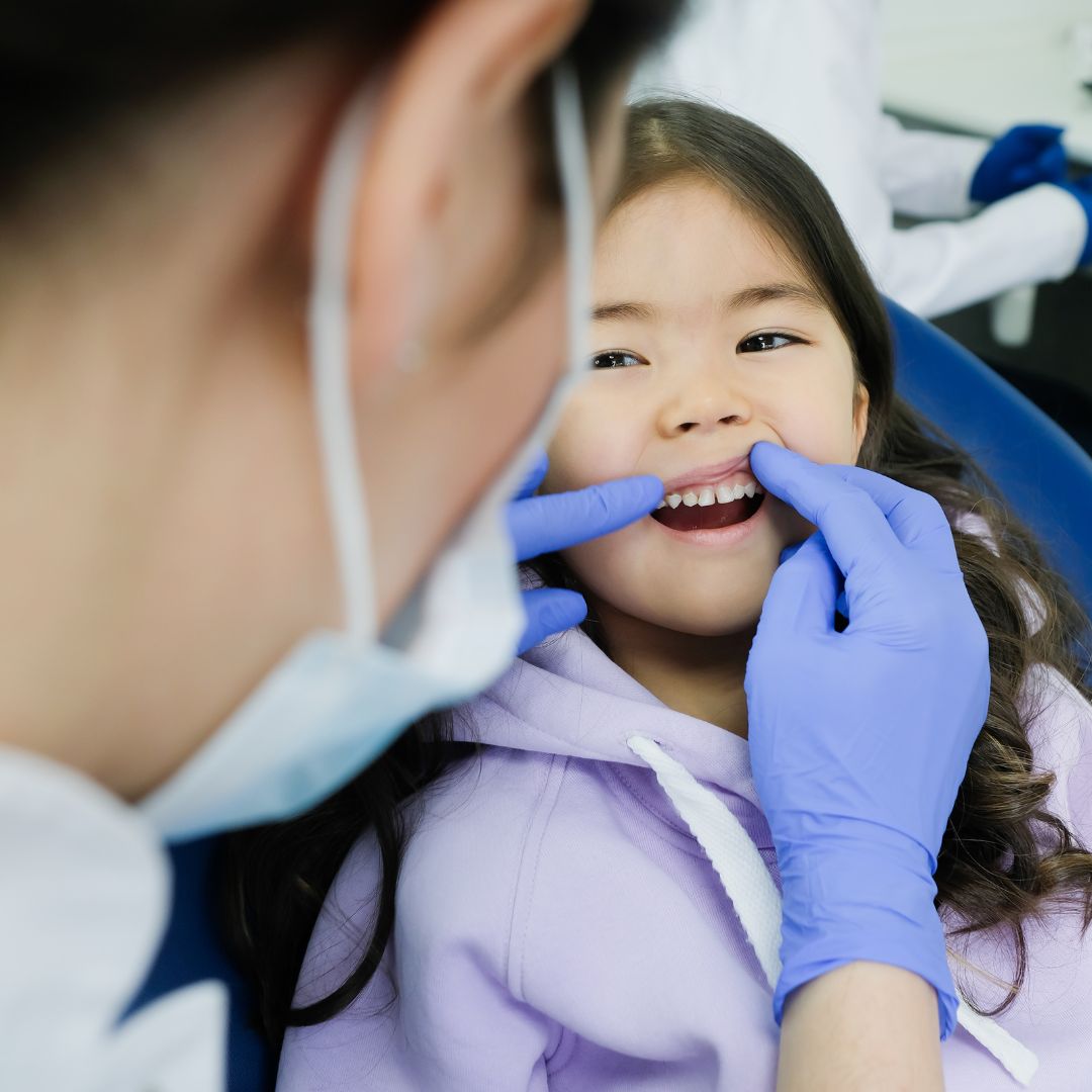smiling child having teeth checked