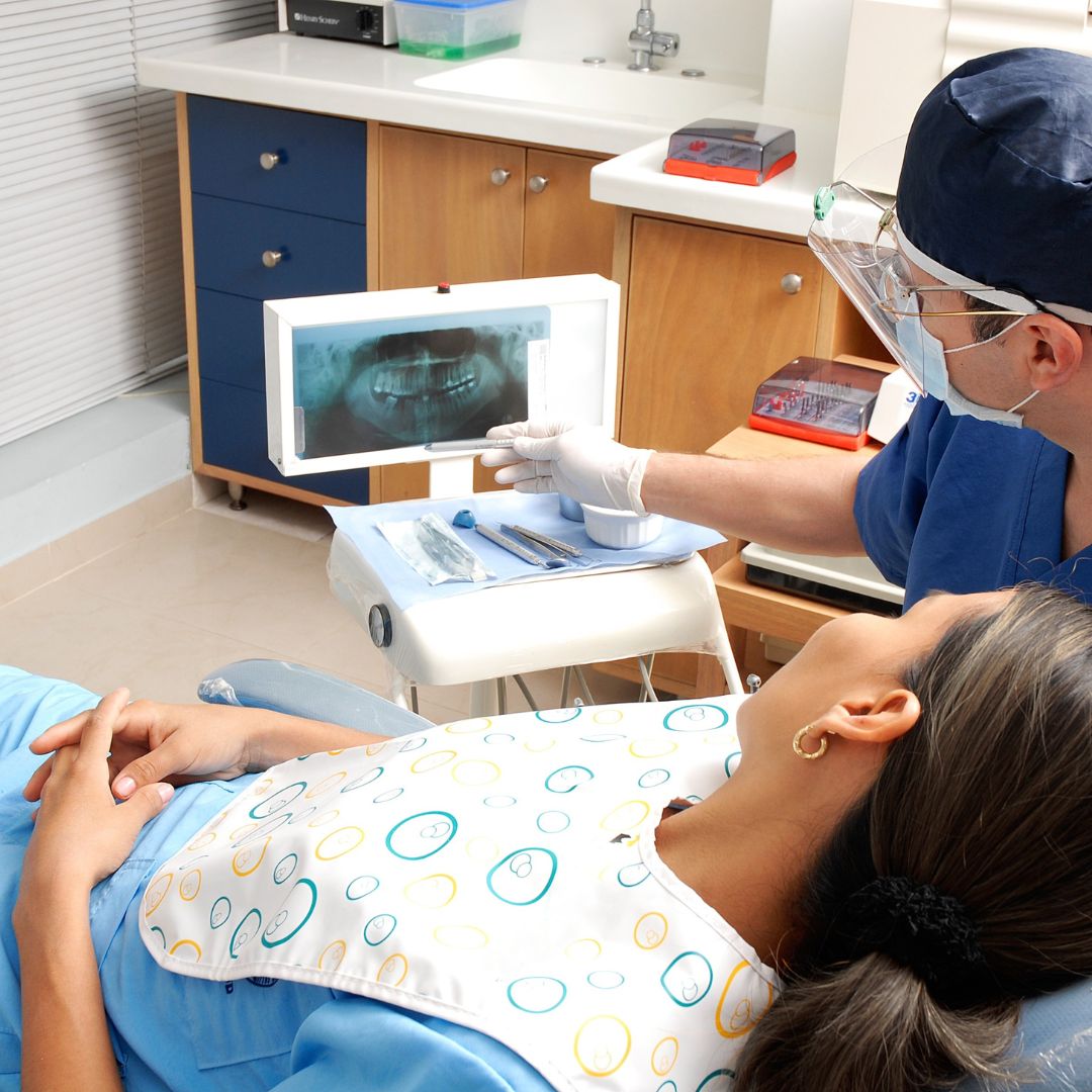 dentist showing patient x-ray