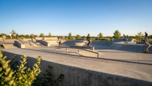 A sunny afternoon view of the Railbender Skate Park in Parker, Colorado, used as a backdrop for a dental emergency guide.